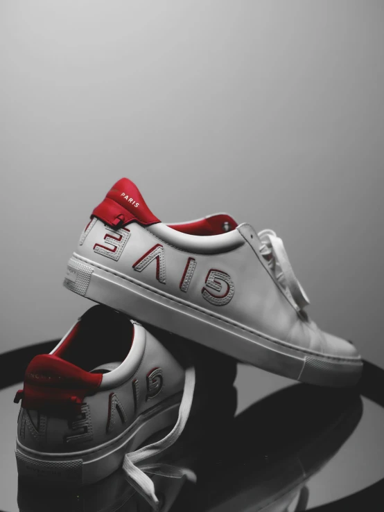 a pair of white and red sneakers with words written on them