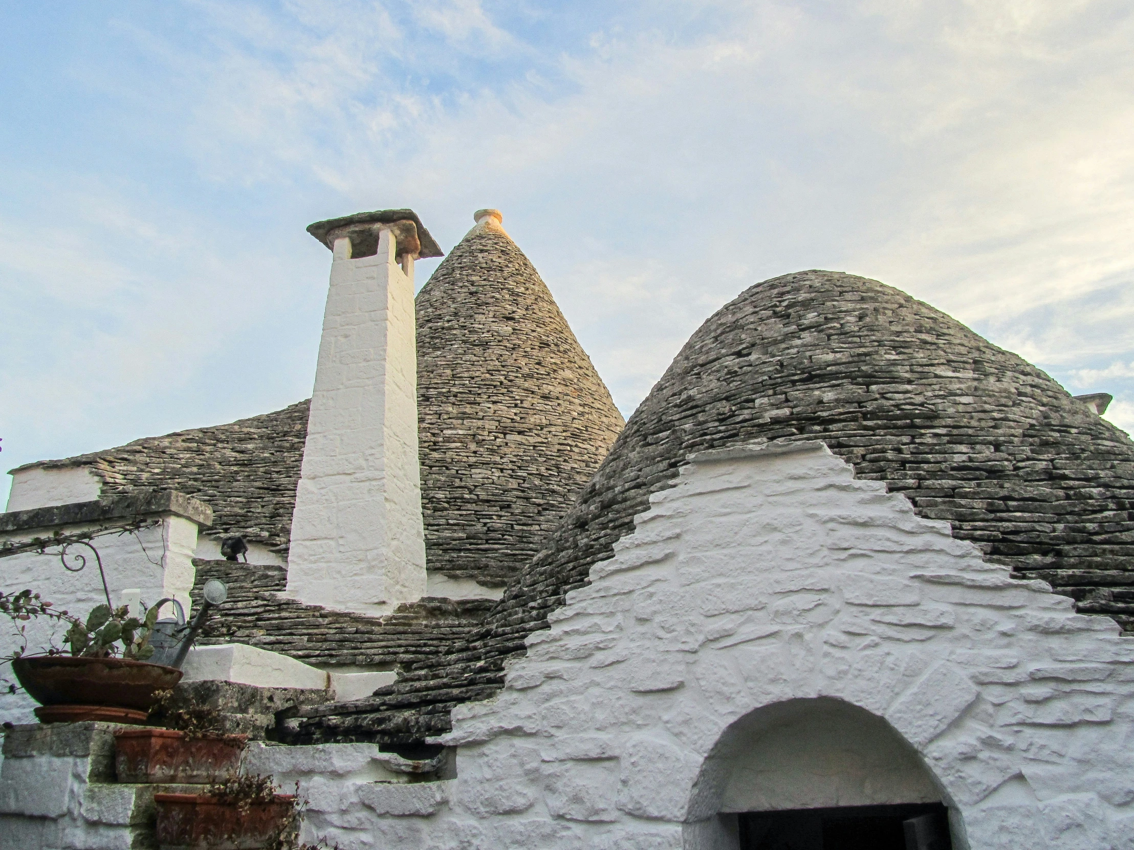 two chimneys with some rocks on the roof