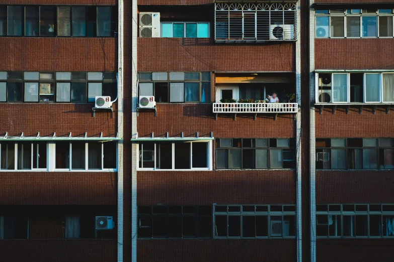 an apartment building with large windows on each side