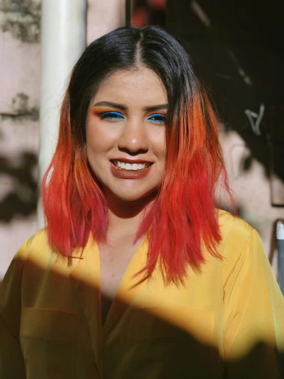 a close up of a woman with bright pink hair and bright blue eyes