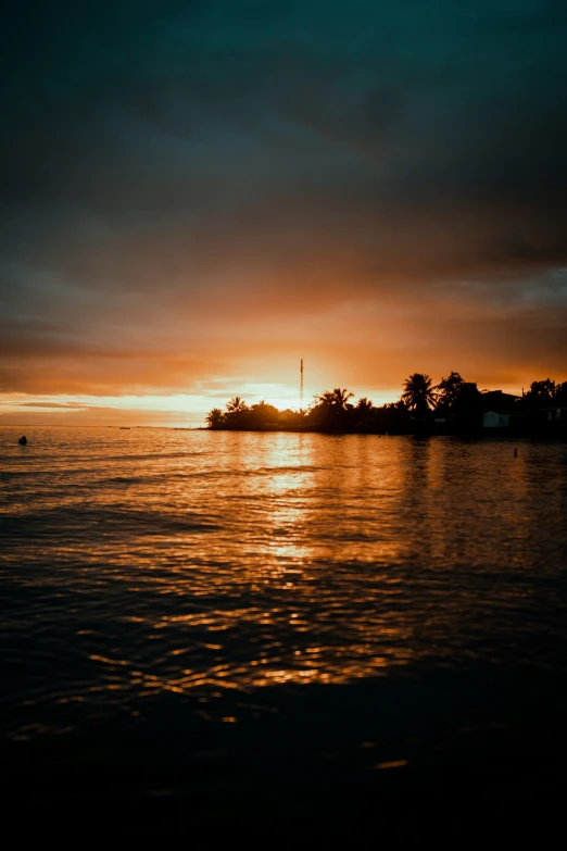 an orange and yellow sunset over a body of water