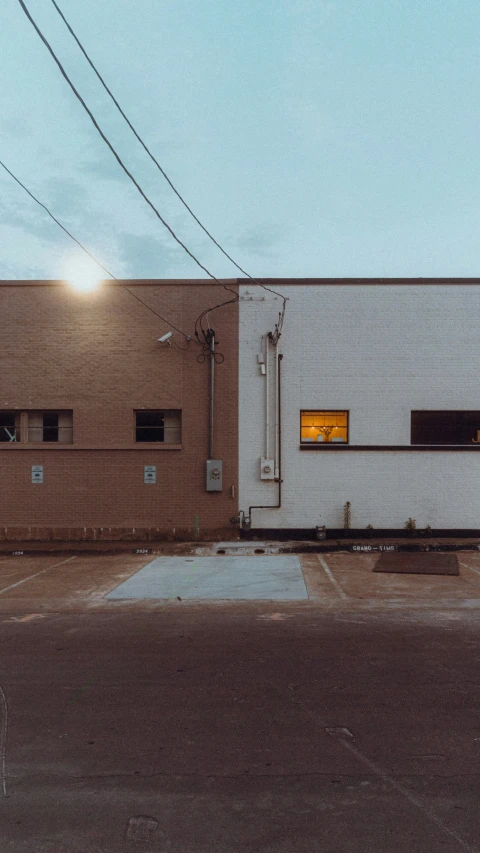 a large long building with windows near an empty street