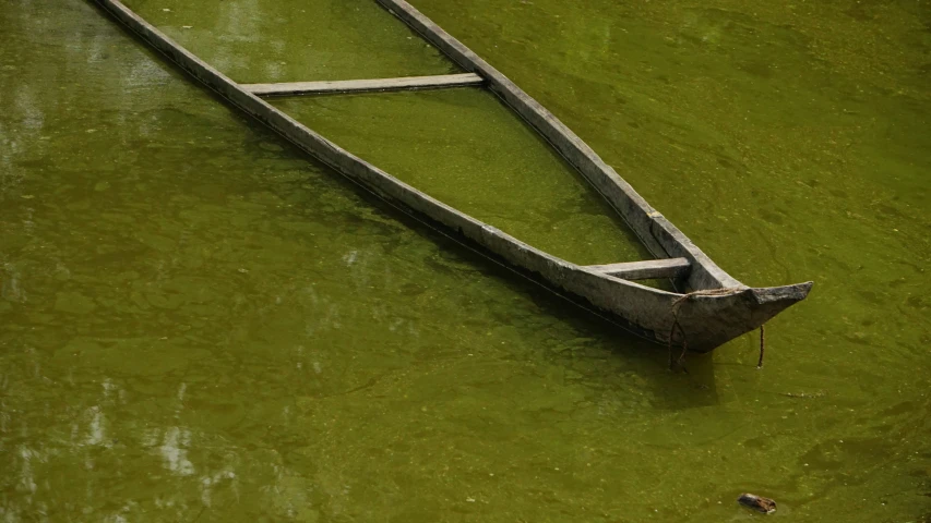 old boat sitting in the middle of the water