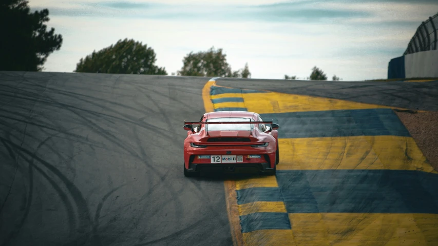 a red car driving on a racing track