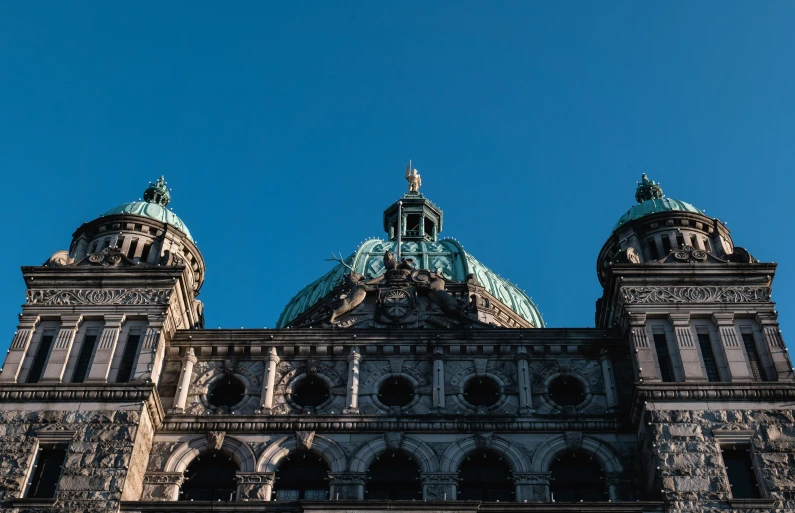 a large building with steeple and some clocks