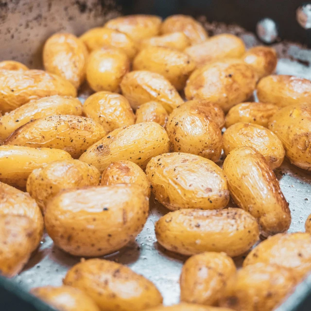 some uncooked potatoes are laying on a sheet