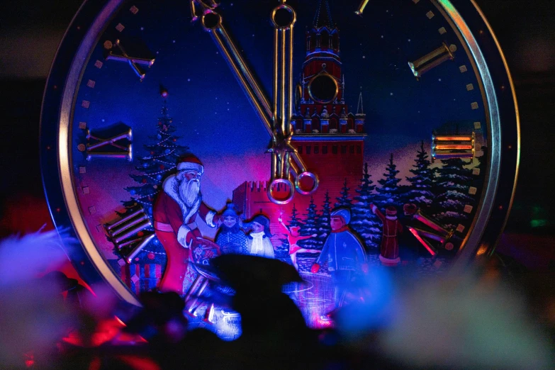 an illuminated clock with a santa claus face is featured at a concert