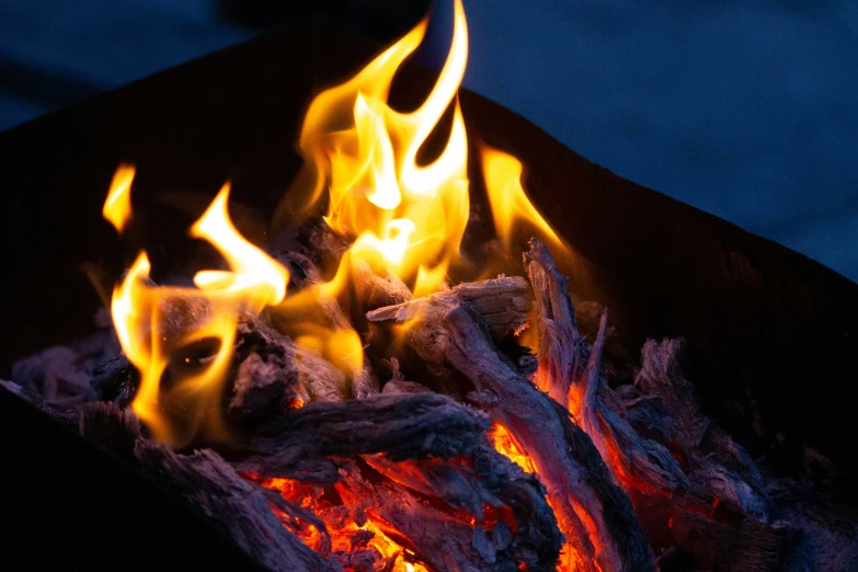 a close up of a fire and flames with other flames in the background