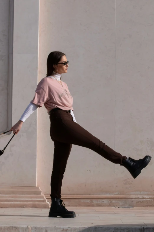 a woman in tight pants walking with a handbag