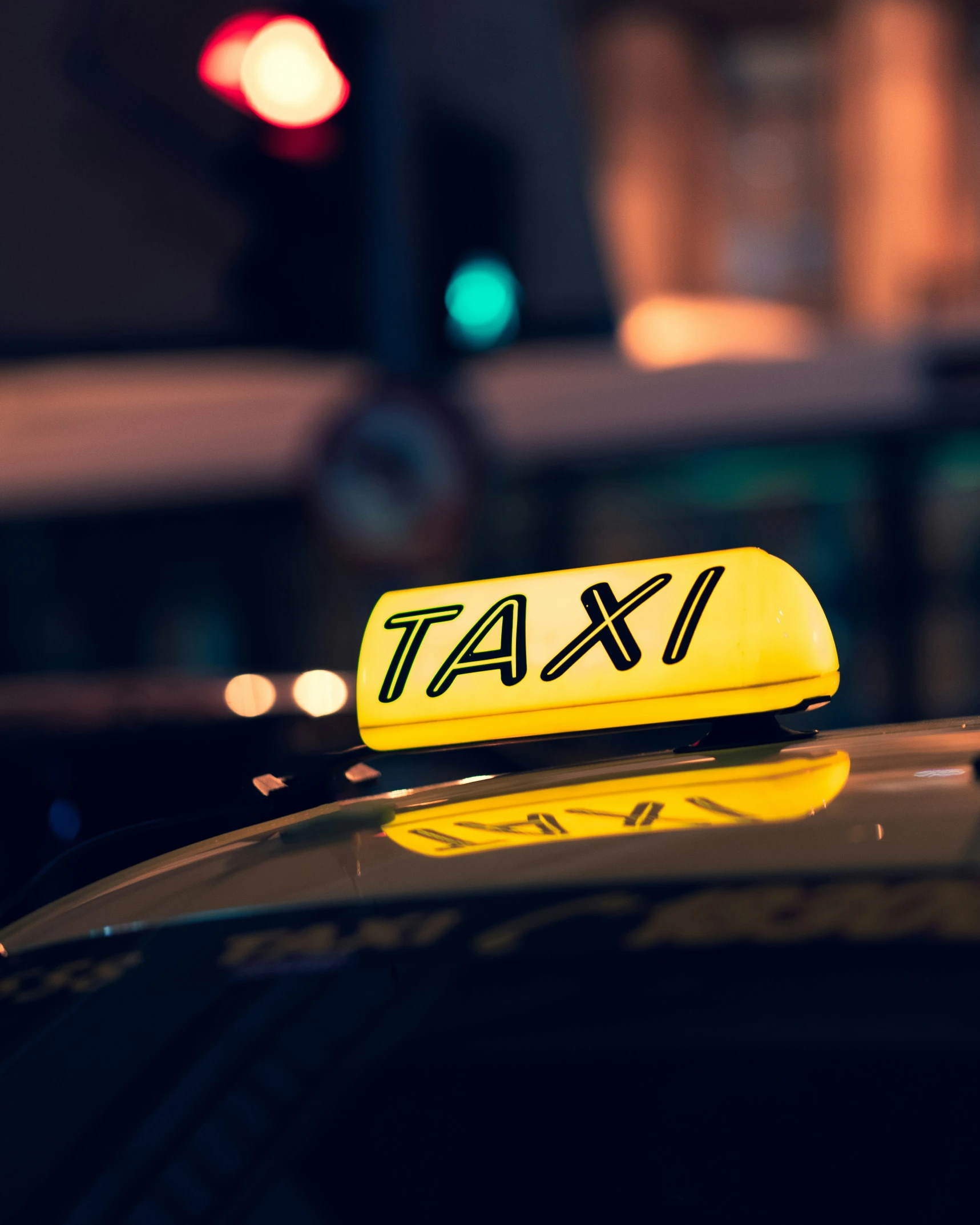 a taxi car with a yellow light above it