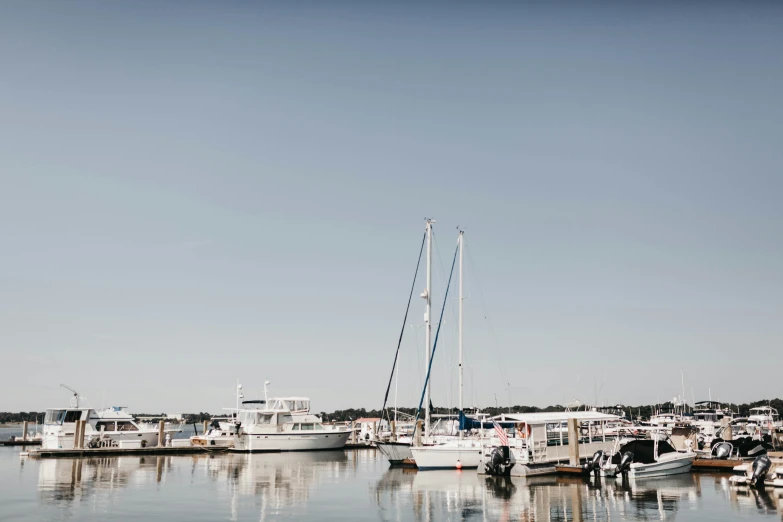 a row of boats floating on top of a lake