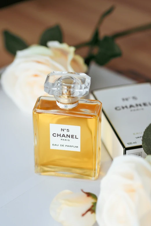 a glass bottle filled with perfume sitting on top of a white table