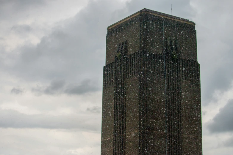 a tall building surrounded by snow and falling water