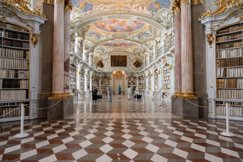 a large, ornate liry with columns in between it and people walking down it