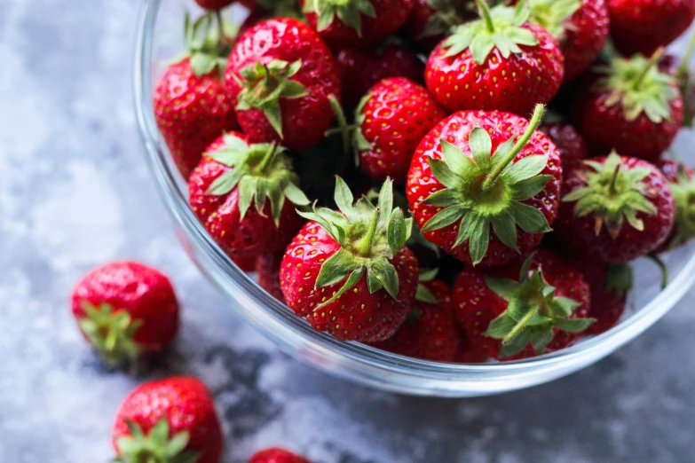 a bunch of strawberries are in a bowl