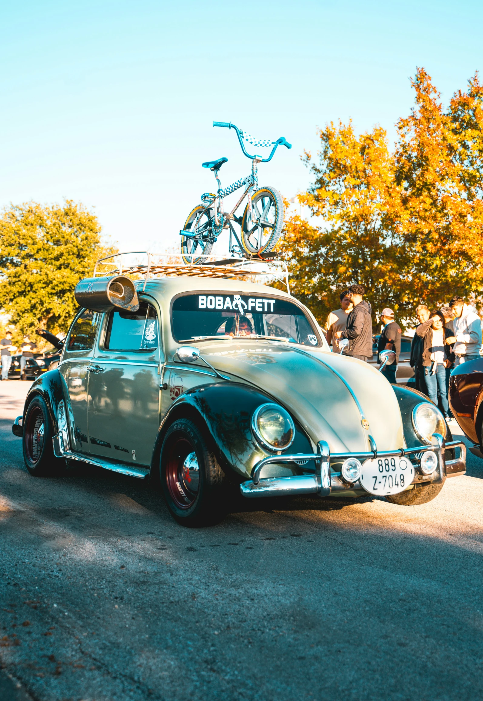 an old timey car that is parked next to another car