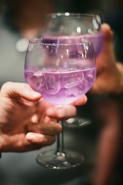 a close up of a person holding a wine glass