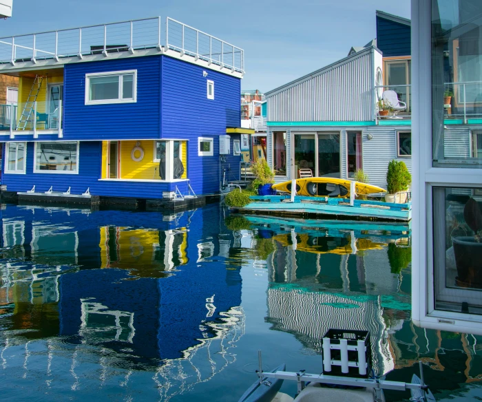 blue houses sit on the water near houses
