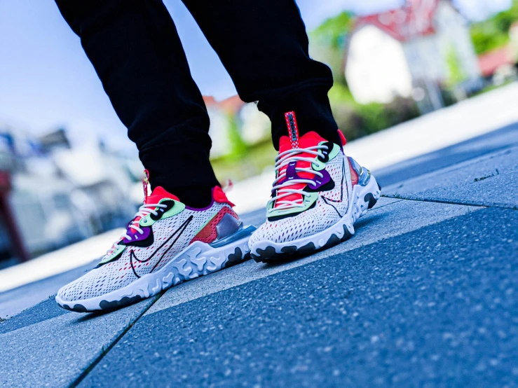 a person's feet on the pavement with a blue sky behind them