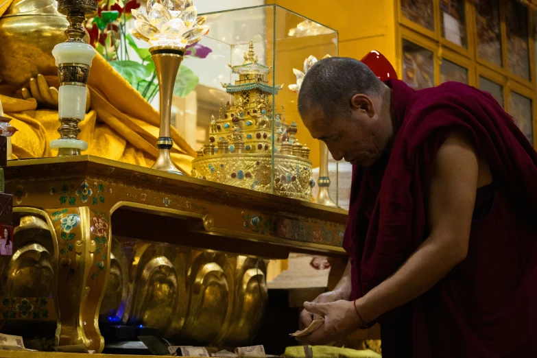 a monk in an old - time temple is making notes for the guest