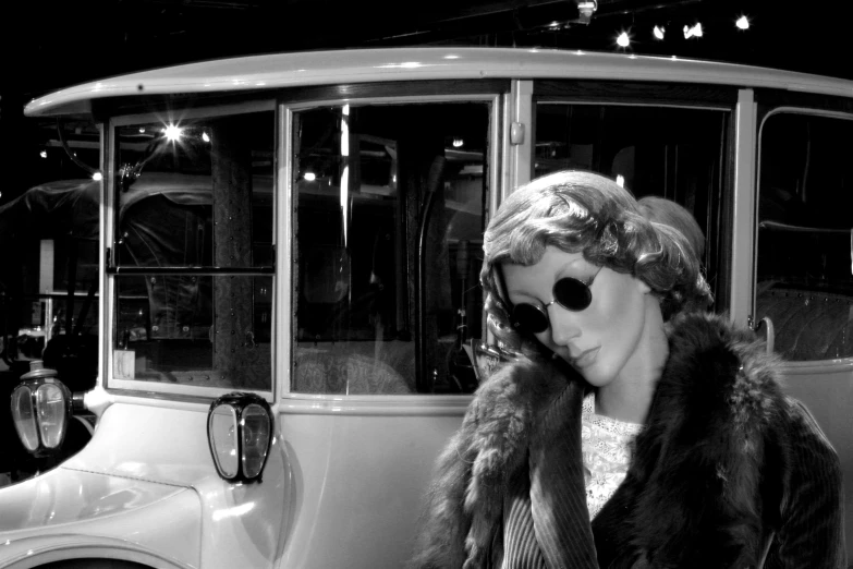 a woman is sitting in the passenger bus in her fur coat