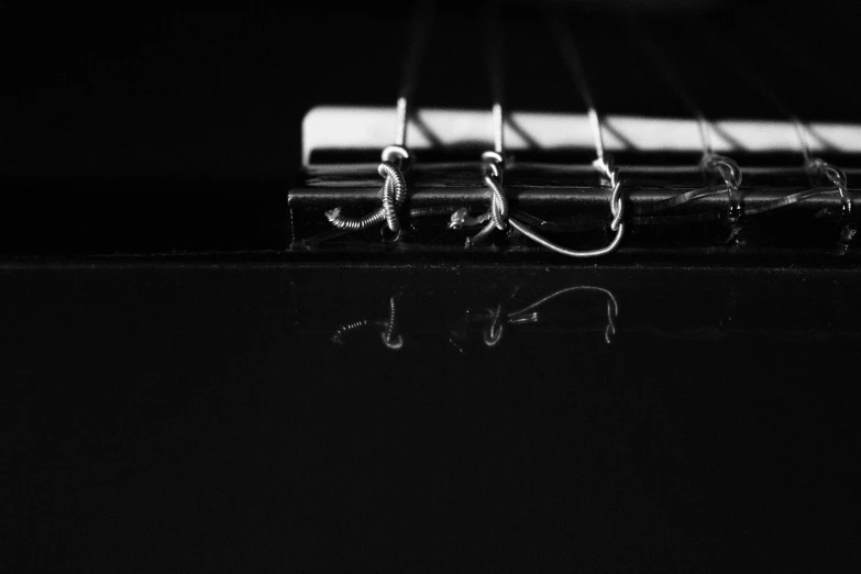 a close up of a guitar strings with the strings pointing up