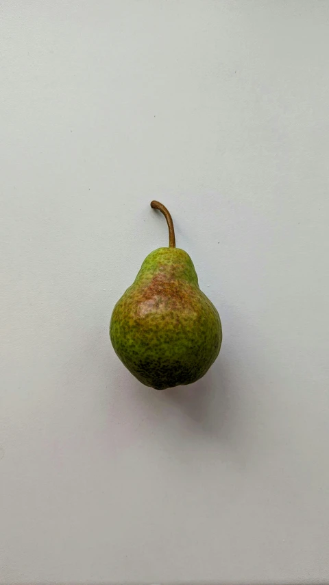 a pear that has been sliced into quarters and is sitting on the floor