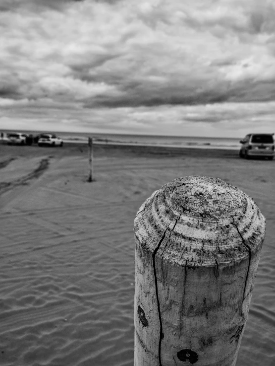 the top end of a concrete pole sticking out from the ocean water