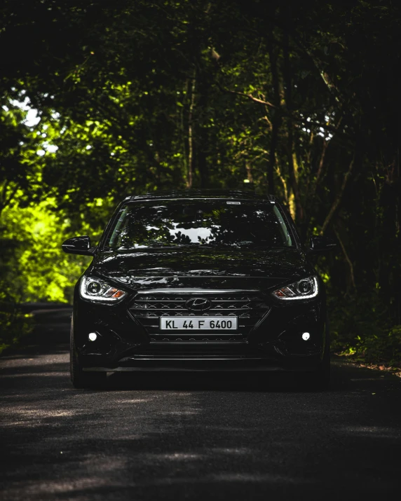 a car parked along a tree lined road