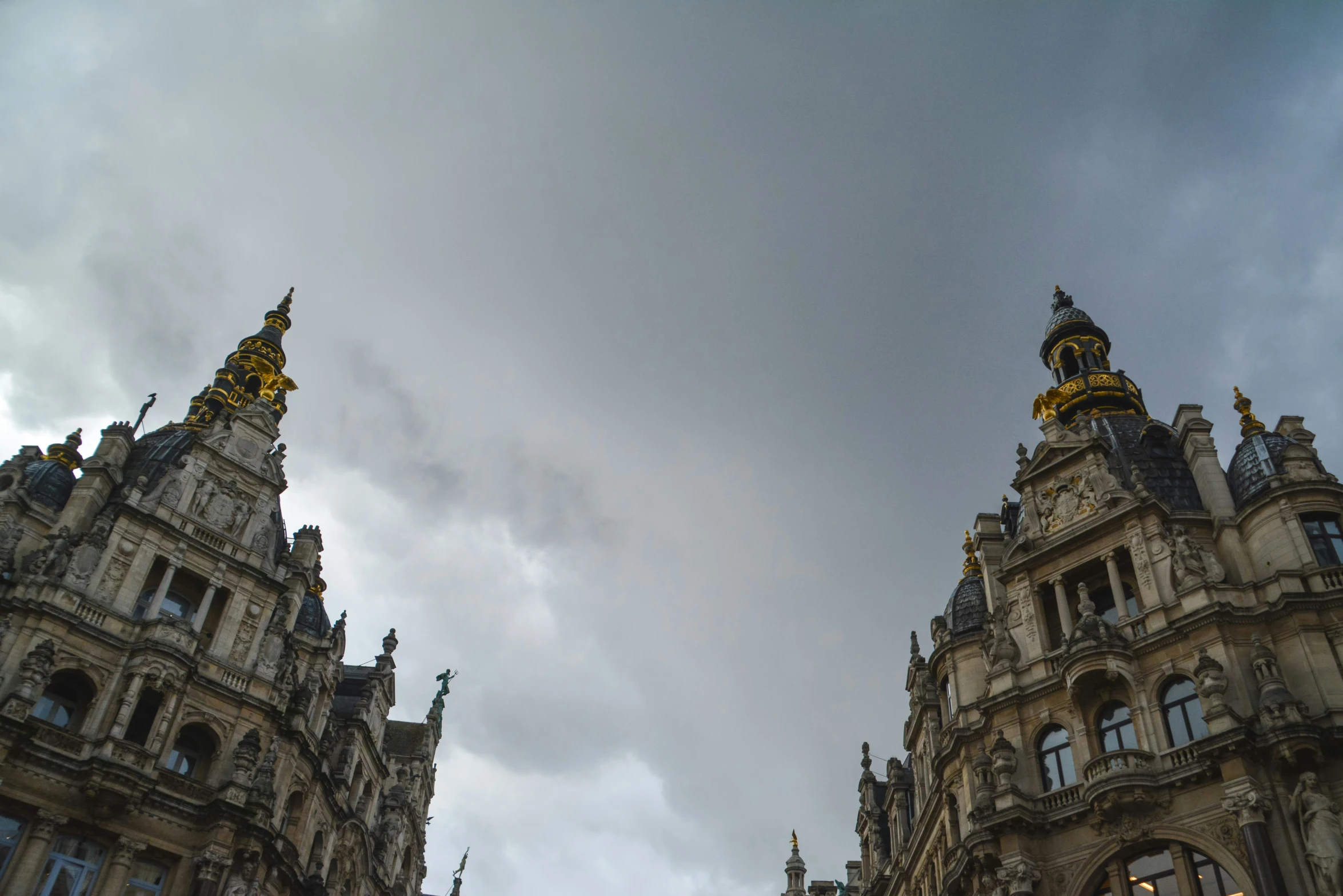 a po of two very tall buildings in a cloudy sky