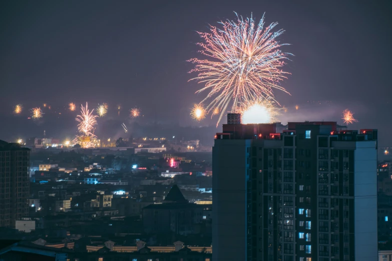 fireworks and lights in the night sky and above buildings