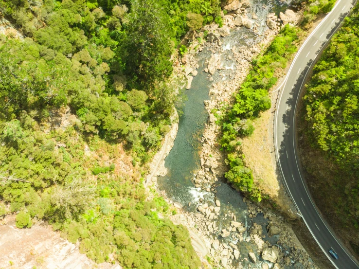 aerial view of winding river and mountains near roadway