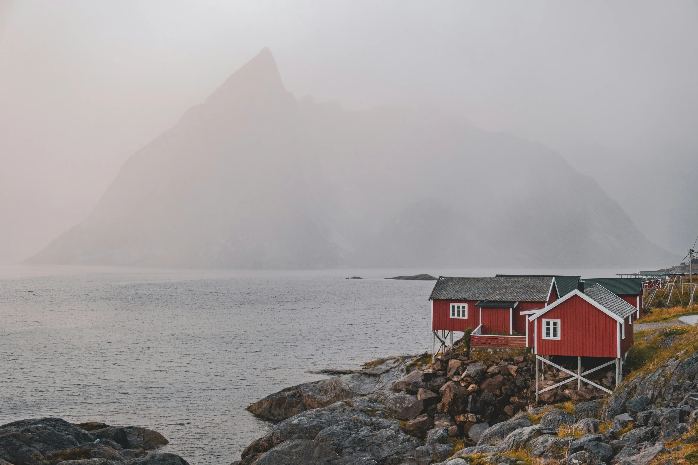 two red buildings are next to some mountains in the background