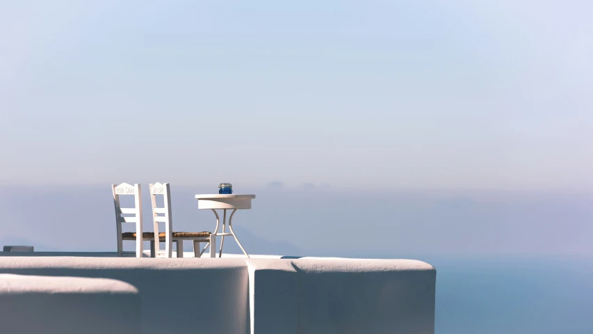 the beach has chairs and a lamp on the pier