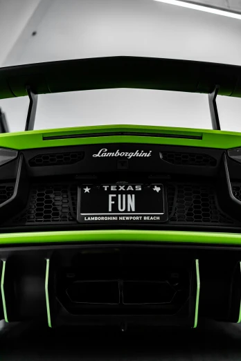 the front of the green sports car with a license plate