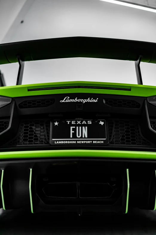 the front of the green sports car with a license plate