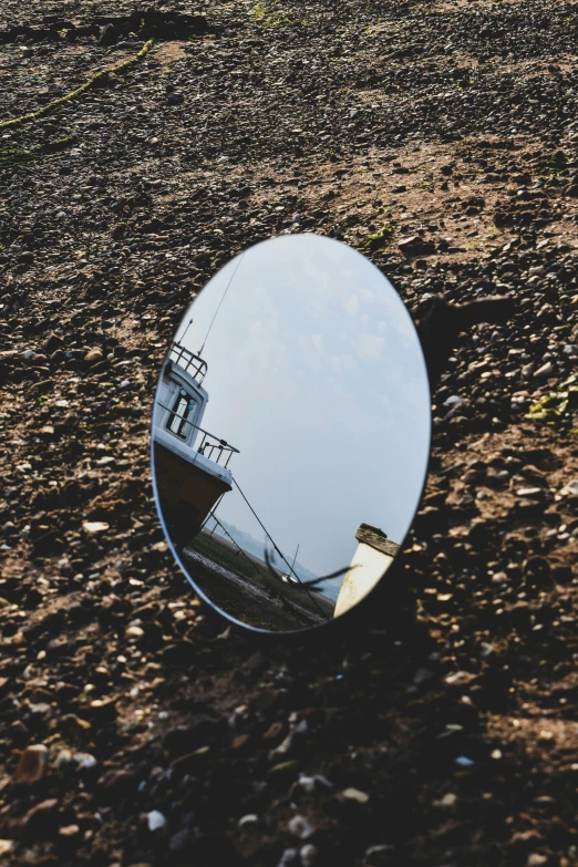 a view of a beach from a mirror looking in