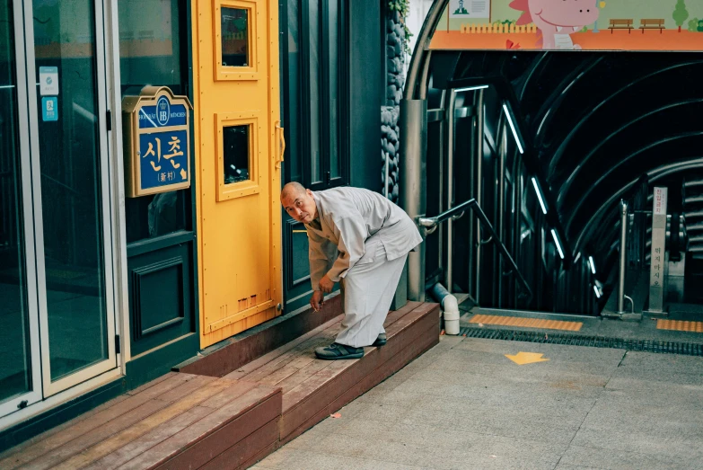 a man stands at the open door of a store