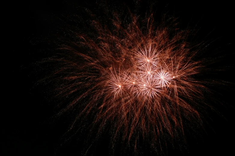 a firework show that is glowing up in the night sky