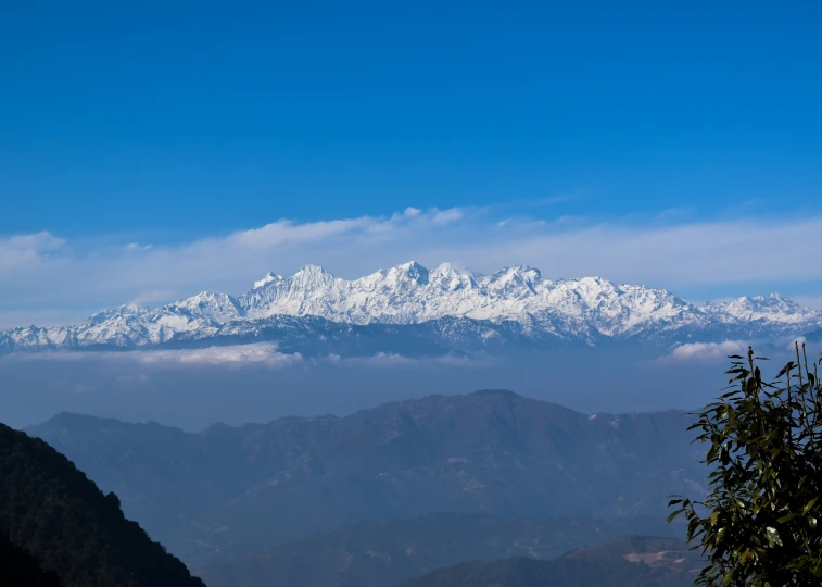 the mountains are covered in snow as seen from below