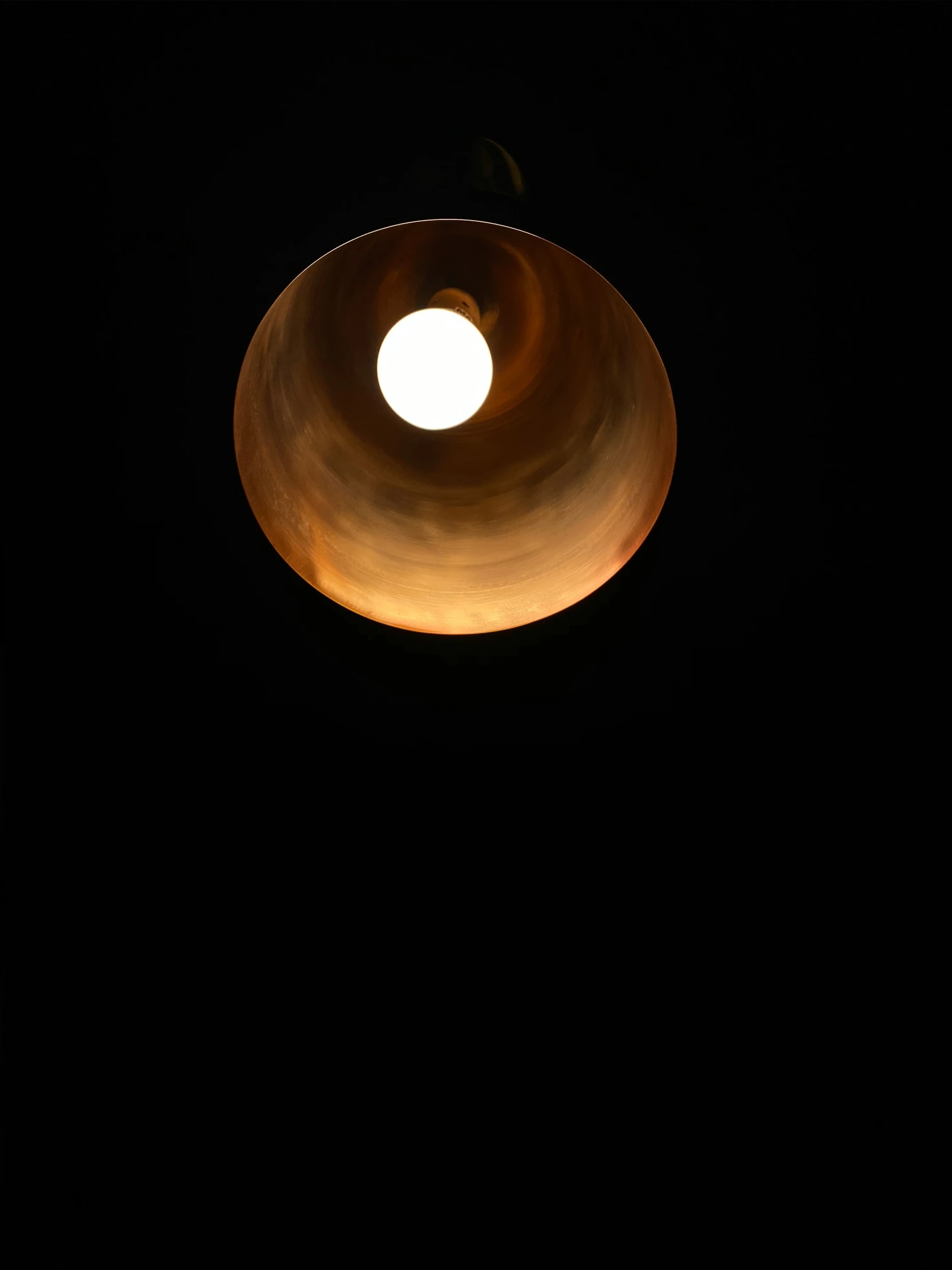 a metal ring suspended in the dark above the ground