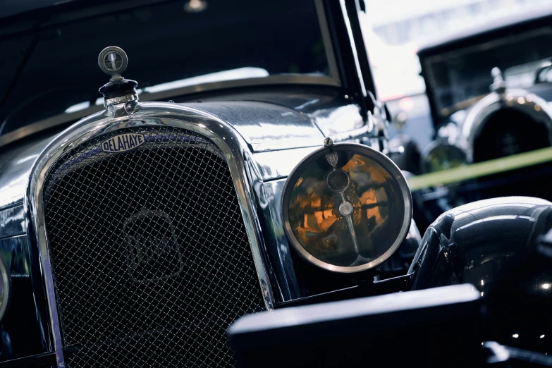 several vintage cars parked in a line at a show