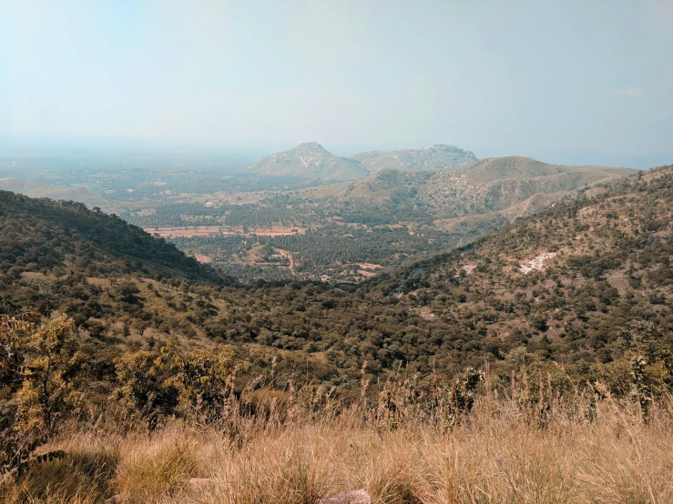 a view of mountains from the top of a hill