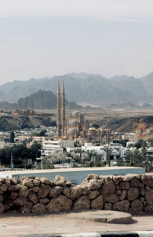 a scenic s of a desert city near a mountain range