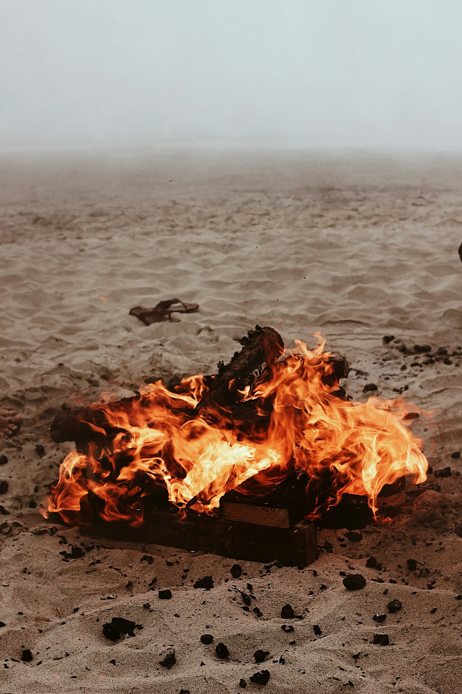 a bonfire with some very bright burnings on the sand