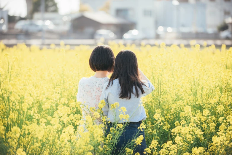 two young ladies in a field of flowers