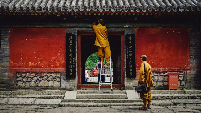 a monk walking up to a doorway