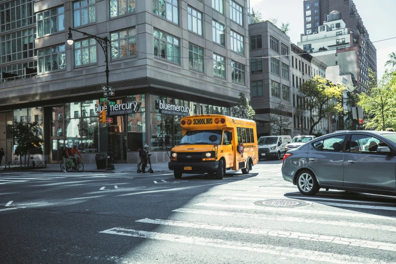 two school buses sitting in traffic on a city street