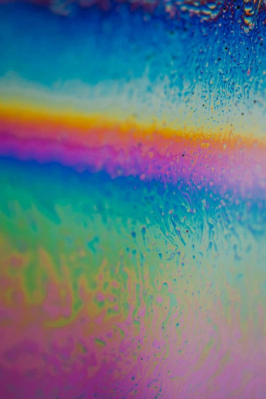 the texture of the paint in pastel colours on glass