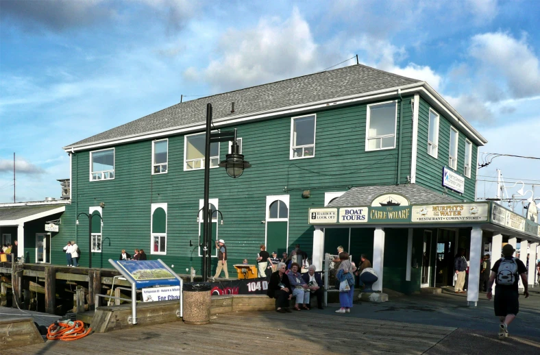 a green building is on the side of the street